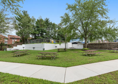 Picnic tables on the grass at Creekside Apartments in Bensalem