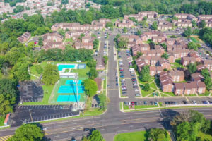 Aerial view of the large apartment complex at Creekside Apartments with outdoor recreation and parking options