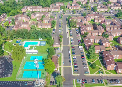 Aerial view of the large apartment complex at Creekside Apartments with outdoor recreation and parking options